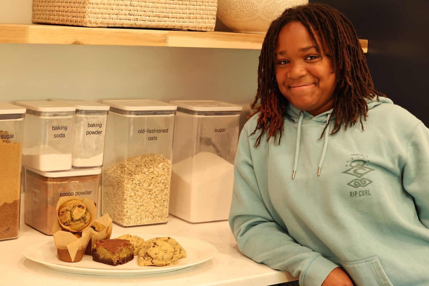 Kaleigh smiling with a plate of her fresh-baked cookies in her Franklin, TN kitchen